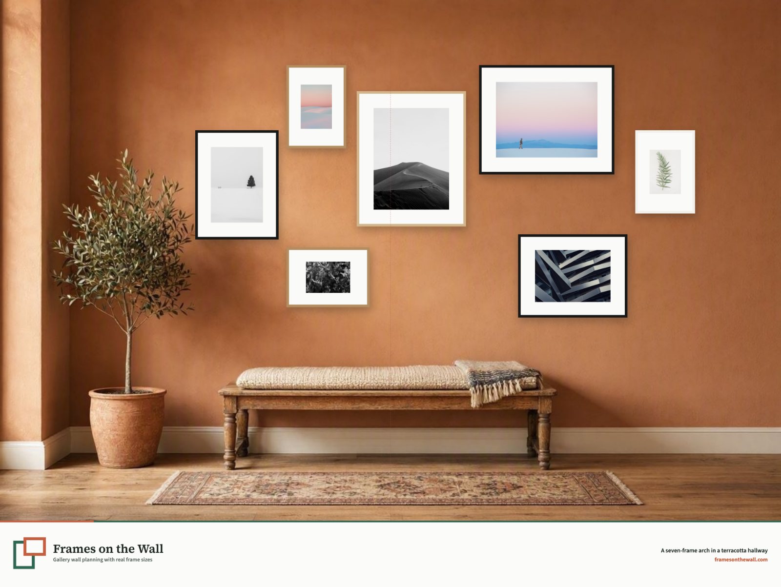 Planner render of seven mixed frames in an arch above an oak bench on a terracotta hallway wall