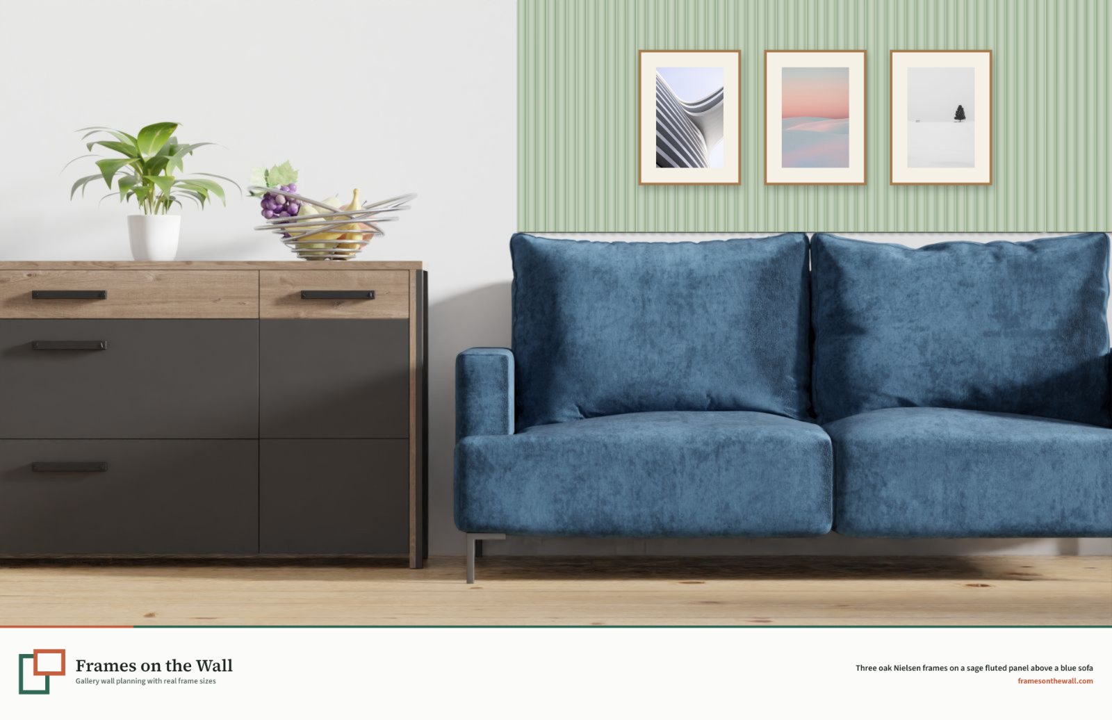 Planner render of three oak Nielsen frames on a sage green fluted wall panel above a blue velvet sofa