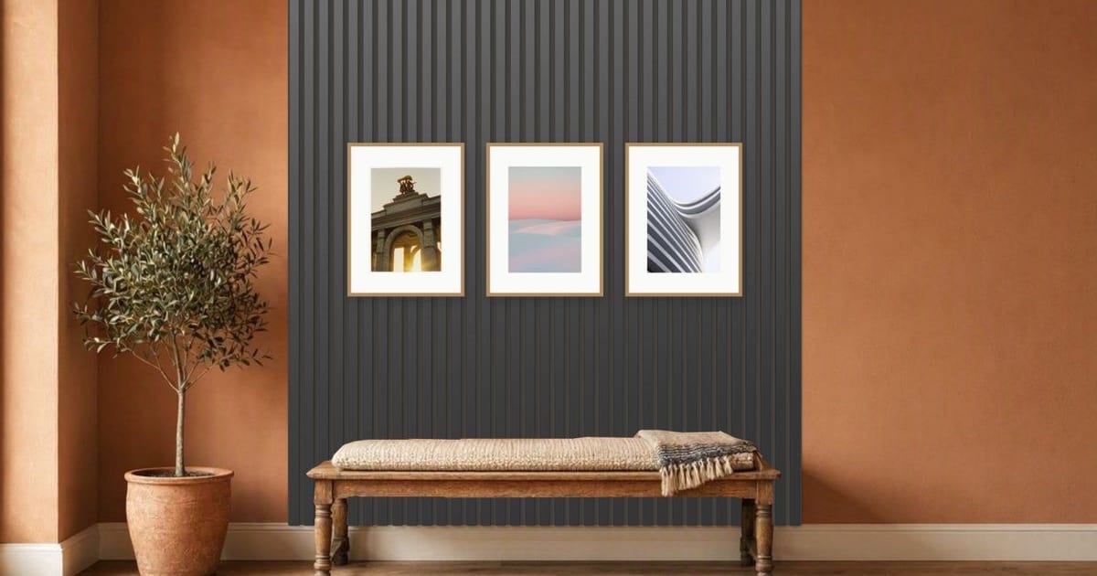 Black acoustic slats with three oak frames above a bench in a terracotta hallway